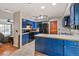 Spacious kitchen with blue cabinets, white countertops, stainless steel appliances, and tile flooring at 16533 E Baker Pl, Aurora, CO 80013