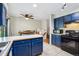 Spacious kitchen with blue cabinets, white countertops, stainless steel appliances, and tile flooring at 16533 E Baker Pl, Aurora, CO 80013