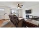 Comfortable living room with sofas, ceiling fan and large window allowing natural light to illuminate the hardwood flooring at 16533 E Baker Pl, Aurora, CO 80013