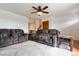 Comfortable living room with sofas, ceiling fan and large window allowing natural light to illuminate the hardwood flooring at 16533 E Baker Pl, Aurora, CO 80013