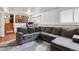 Cozy living room featuring neutral sectional sofa on top of a swirling pattern rug at 16533 E Baker Pl, Aurora, CO 80013