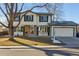 Two-story house with attached garage, landscaping, and a tree in front at 7379 S Syracuse Ct, Centennial, CO 80112