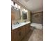 Bathroom with double sink vanity, updated fixtures, and tiled shower with tub at 9322 Jackson St, Thornton, CO 80229