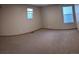 A cozy carpeted bedroom with large windows at 9322 Jackson St, Thornton, CO 80229
