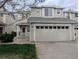 Charming two-story townhome showcasing a light gray exterior, a two-car garage, and manicured lawn at 9322 Jackson St, Thornton, CO 80229