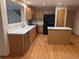 Bright kitchen featuring an island, wood cabinetry, and stainless steel appliances at 9322 Jackson St, Thornton, CO 80229