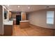 Open kitchen with wood floors, island, stainless steel appliances, and wood cabinets at 9322 Jackson St, Thornton, CO 80229
