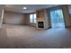 Spacious living room with fireplace and sliding glass door leading to outdoor space at 9322 Jackson St, Thornton, CO 80229