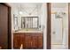 Cozy bathroom featuring vintage-style fixtures, a vanity, and a shower with gold trim at 2742 S Xanadu Way, Aurora, CO 80014