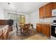 Bright dining area featuring wood cabinets, a round table with chairs, and a sliding glass door at 2742 S Xanadu Way, Aurora, CO 80014
