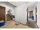 Inviting entryway featuring tile flooring, a staircase, and access to various rooms in the home at 2742 S Xanadu Way, Aurora, CO 80014