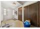 Bright entryway featuring neutral walls, tile flooring, closet space, and white front door at 2742 S Xanadu Way, Aurora, CO 80014