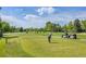Scenic golf course view featuring a golfer teeing off with golf carts and lush green fairways at 2742 S Xanadu Way, Aurora, CO 80014