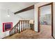 Hallway with railing overlooking staircase leading to a living area at 2742 S Xanadu Way, Aurora, CO 80014
