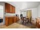 The eating area sits next to the kitchen with wooden cabinets and floors at 2742 S Xanadu Way, Aurora, CO 80014