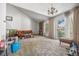 Spacious living room with high ceilings, stone fireplace, and a sliding glass door for natural light at 2742 S Xanadu Way, Aurora, CO 80014