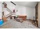 Large living room featuring a staircase, stone fireplace, and ample space for furniture arrangement at 2742 S Xanadu Way, Aurora, CO 80014