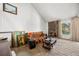 Cozy living room with a vaulted ceiling, stone fireplace, and abundant natural light from the windows at 2742 S Xanadu Way, Aurora, CO 80014