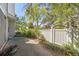 Private patio area featuring concrete flooring, a white wooden fence, and surrounding lush greenery at 2742 S Xanadu Way, Aurora, CO 80014