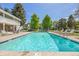 Inviting community pool with clear blue water, surrounded by lounge chairs and well-maintained landscaping at 2742 S Xanadu Way, Aurora, CO 80014