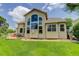 Stunning backyard of a home featuring a lush green lawn, patio and exterior wall of large windows at 14075 Turnberry Ct, Broomfield, CO 80023