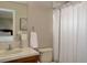 Cozy bathroom featuring a vanity with sink, toilet, and a shower with a white curtain at 14075 Turnberry Ct, Broomfield, CO 80023