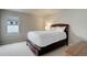 Neutral bedroom showcasing a comfortable bed, soft carpet, and bright natural light from the window at 14075 Turnberry Ct, Broomfield, CO 80023