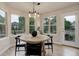 Bright breakfast nook with a round wooden table, four chairs, and plenty of natural light at 14075 Turnberry Ct, Broomfield, CO 80023