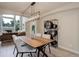 Modern dining room with a long table and decorative shelving, open to living room at 14075 Turnberry Ct, Broomfield, CO 80023
