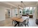 Modern dining room with a long table, open to living room with large windows at 14075 Turnberry Ct, Broomfield, CO 80023