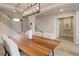 Dining room with modern light fixture, a wood dining table, and neutral colored decor at 14075 Turnberry Ct, Broomfield, CO 80023