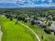Aerial view of houses in a fenced community near a golf course at 14075 Turnberry Ct, Broomfield, CO 80023