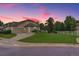 Inviting home exterior with mature trees, landscaping, and driveway at 14075 Turnberry Ct, Broomfield, CO 80023