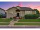 Beautiful single-story home with a well-maintained lawn, flower beds and inviting entrance at sunset at 14075 Turnberry Ct, Broomfield, CO 80023