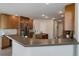 Open concept kitchen with stainless steel appliances, wooden cabinetry, and an eat-in breakfast bar at 14075 Turnberry Ct, Broomfield, CO 80023