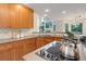 Charming kitchen features warm wood cabinets, stylish countertops, and a bright, airy atmosphere at 14075 Turnberry Ct, Broomfield, CO 80023