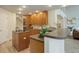 Spacious kitchen with wood cabinets, a breakfast bar, and an abundance of counter space at 14075 Turnberry Ct, Broomfield, CO 80023