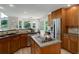 Open kitchen with a large island, wood cabinets, stainless steel appliances, and plenty of natural light at 14075 Turnberry Ct, Broomfield, CO 80023