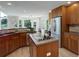 Kitchen with stainless steel appliances, wood cabinets, and a large island at 14075 Turnberry Ct, Broomfield, CO 80023