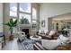 Spacious living room featuring a large window, fireplace, and stylish furniture, open to dining at 14075 Turnberry Ct, Broomfield, CO 80023