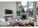 Spacious living room featuring a large window, fireplace, and stylish furniture at 14075 Turnberry Ct, Broomfield, CO 80023