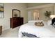 Serene main bedroom with a dresser, tray with wine glasses, and an adjacent sitting area for relaxation at 14075 Turnberry Ct, Broomfield, CO 80023