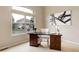 Bright office space with dark wood desk, white chair, and large window view at 14075 Turnberry Ct, Broomfield, CO 80023