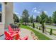 Beautiful patio with lounge furniture and landscaped yard overlooking the street at 14075 Turnberry Ct, Broomfield, CO 80023