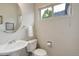 Clean and simple powder room featuring a pedestal sink and neutral finishes at 14075 Turnberry Ct, Broomfield, CO 80023