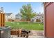 Backyard featuring a green lawn, a garden, trees, and an AC Unit at 6776 S Independence St, Littleton, CO 80128