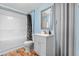 Cozy bathroom featuring a gray vanity, toilet, and a shower with a black and white curtain at 6776 S Independence St, Littleton, CO 80128