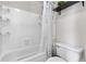 Bathroom with a tiled tub/shower combo and a modern shower curtain at 6776 S Independence St, Littleton, CO 80128
