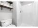 Modern bathroom featuring a tiled shower and dark wood shelves at 6776 S Independence St, Littleton, CO 80128