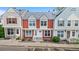 Inviting two-story townhome with colorful facade, landscaped front, and dedicated parking at 6776 S Independence St, Littleton, CO 80128